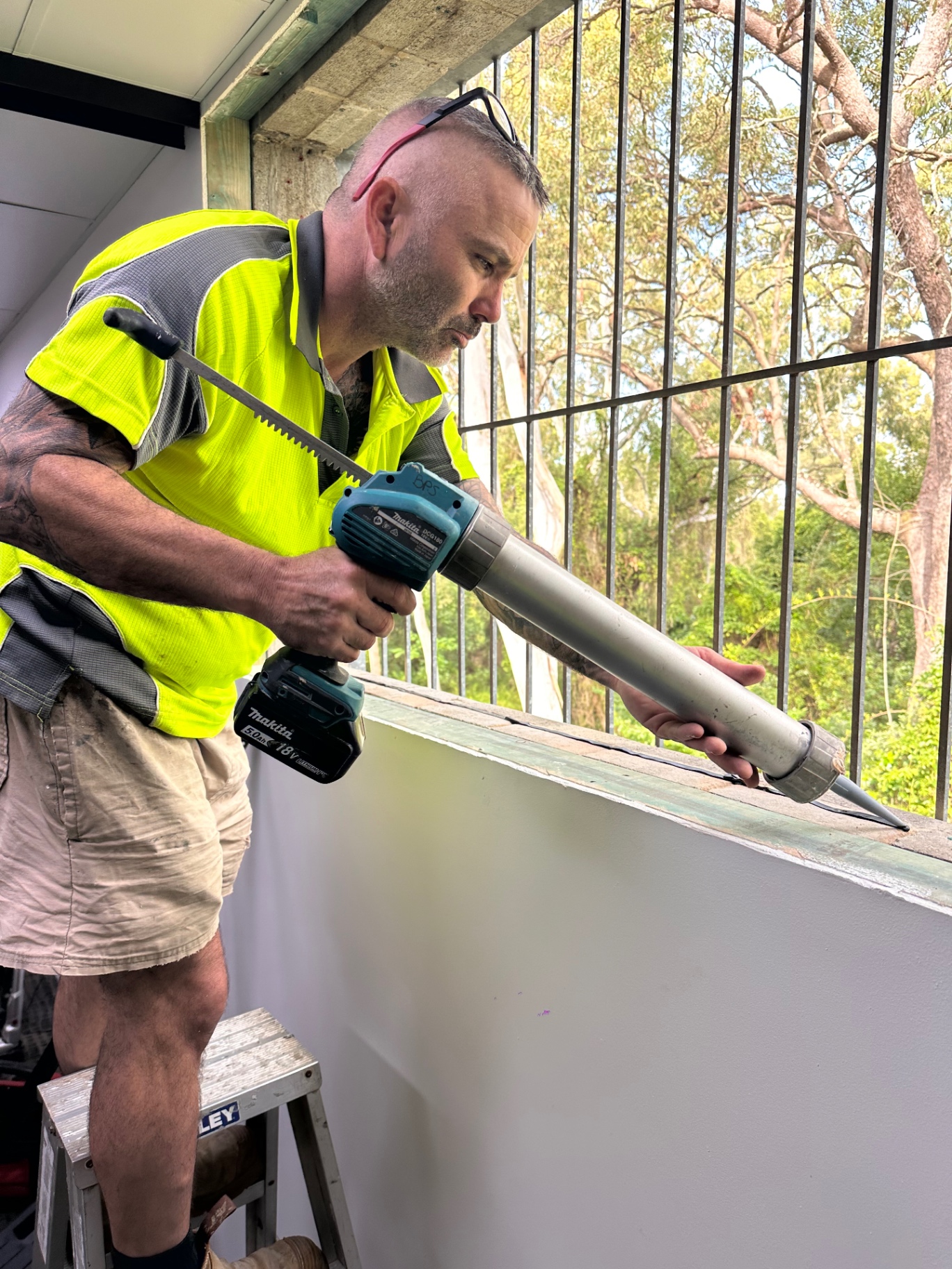 Tradesperson applying sealant during a window installation