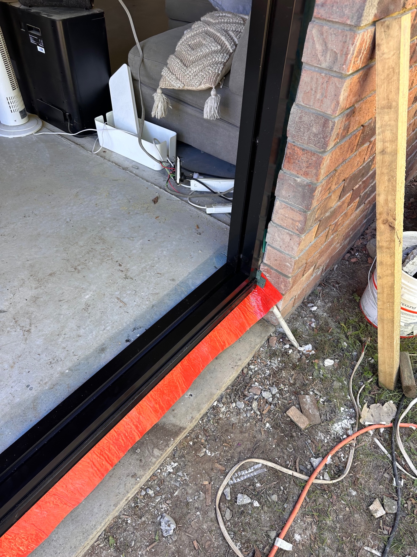 Close-up of a newly fitted black doorway threshold and flashing detail